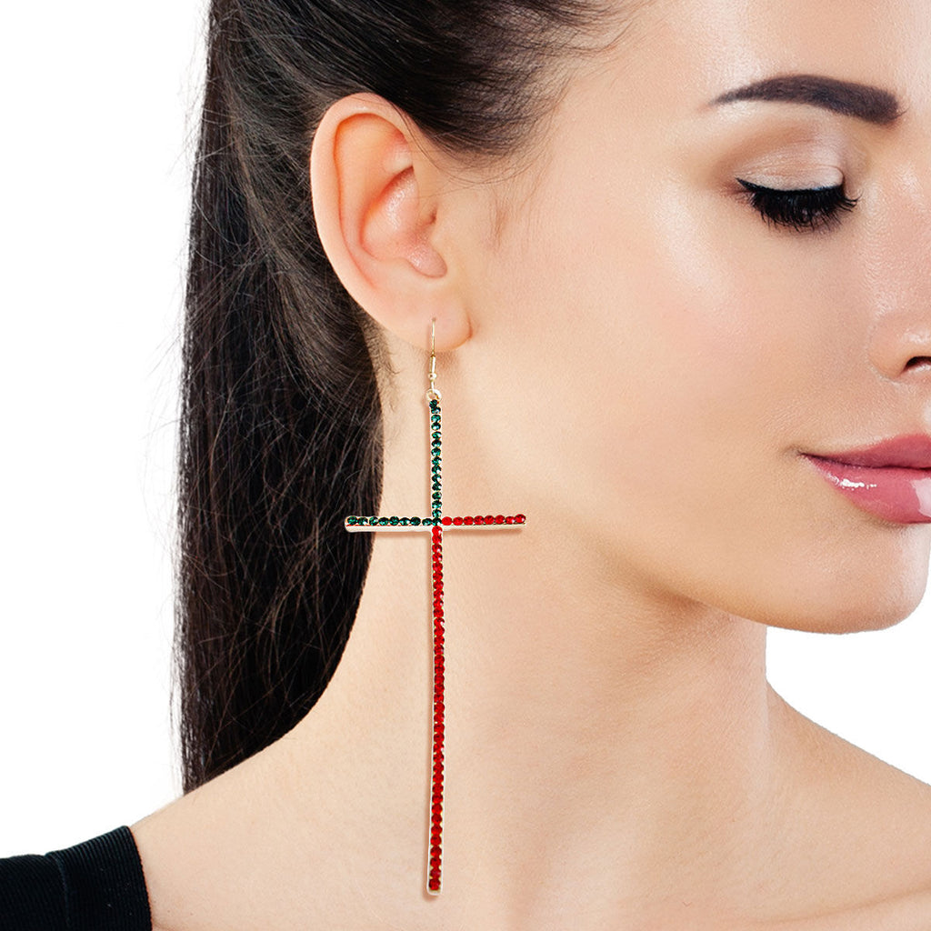 Sparkling rhinestone cross earrings worn on ear side view divine