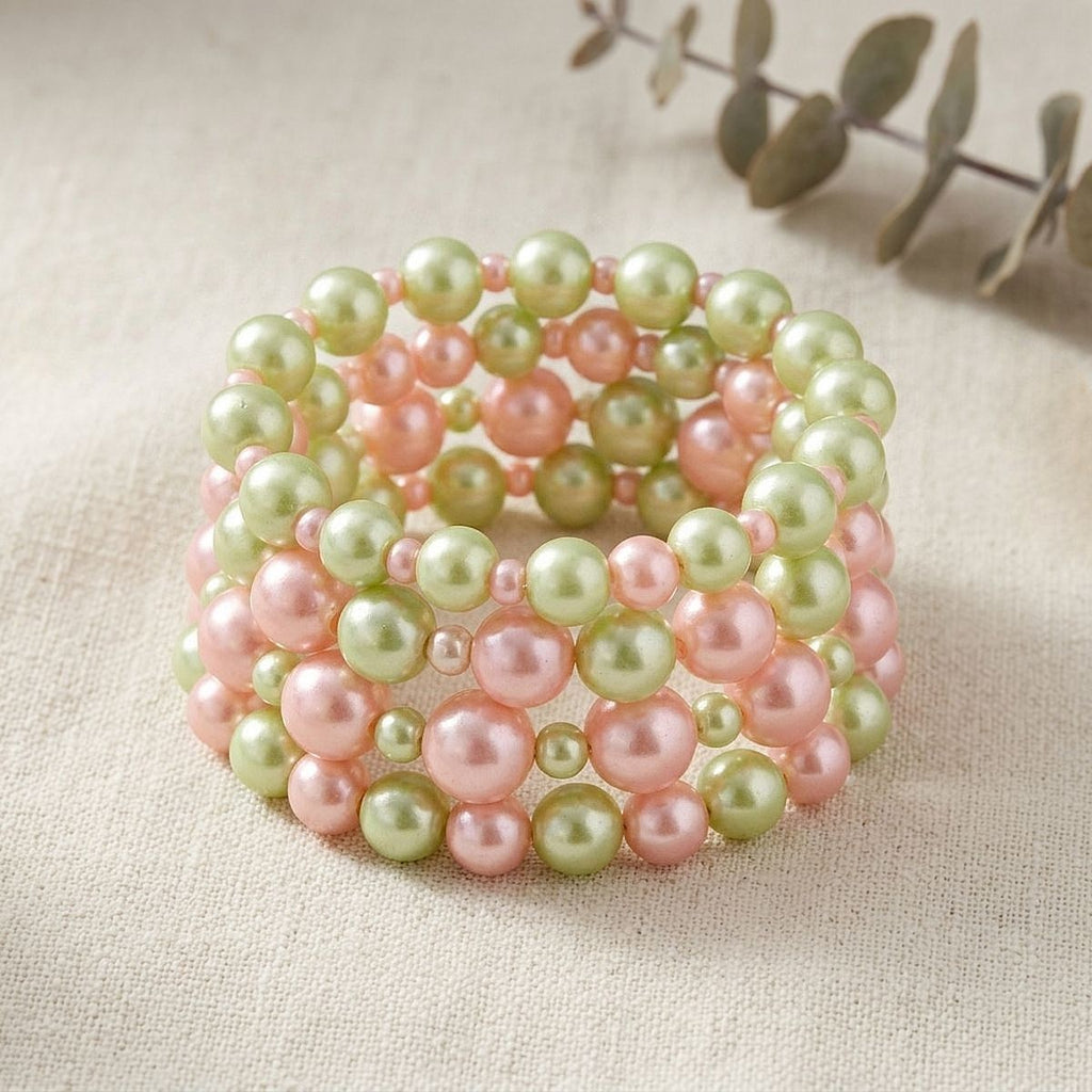 Pink green 5 piece pearl stretch bracelet set flat lay
