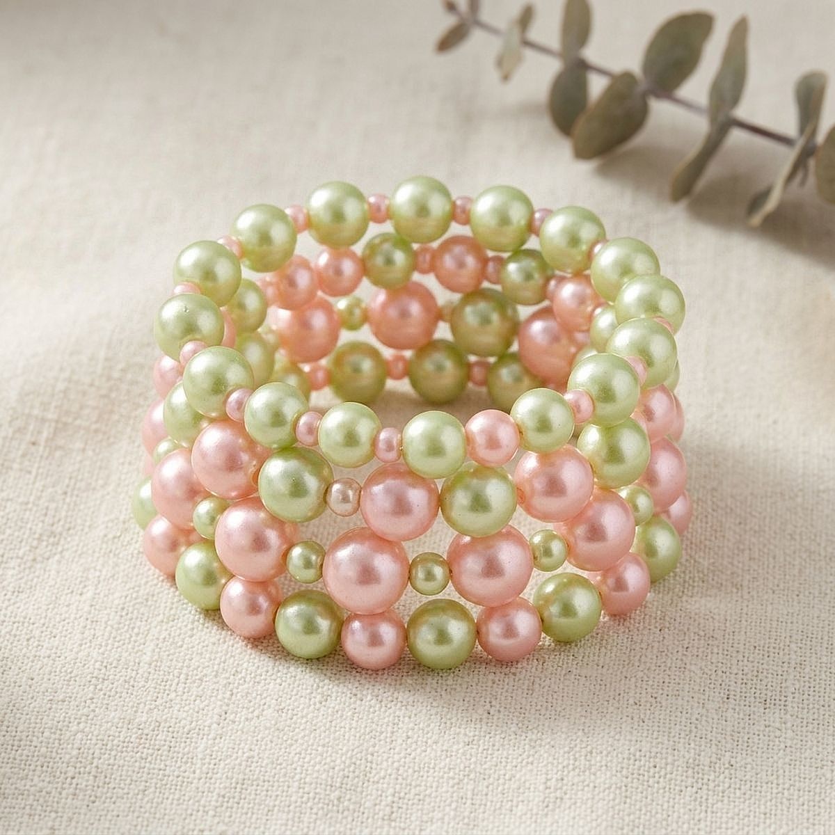 Pink green 5 piece pearl stretch bracelet set flat lay