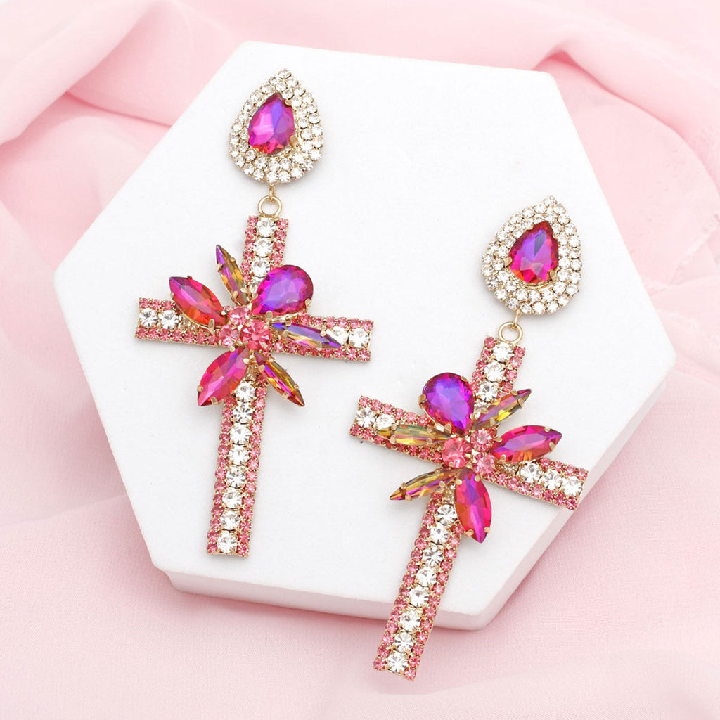Long formal purple cross drop earrings worn on ear side view gold