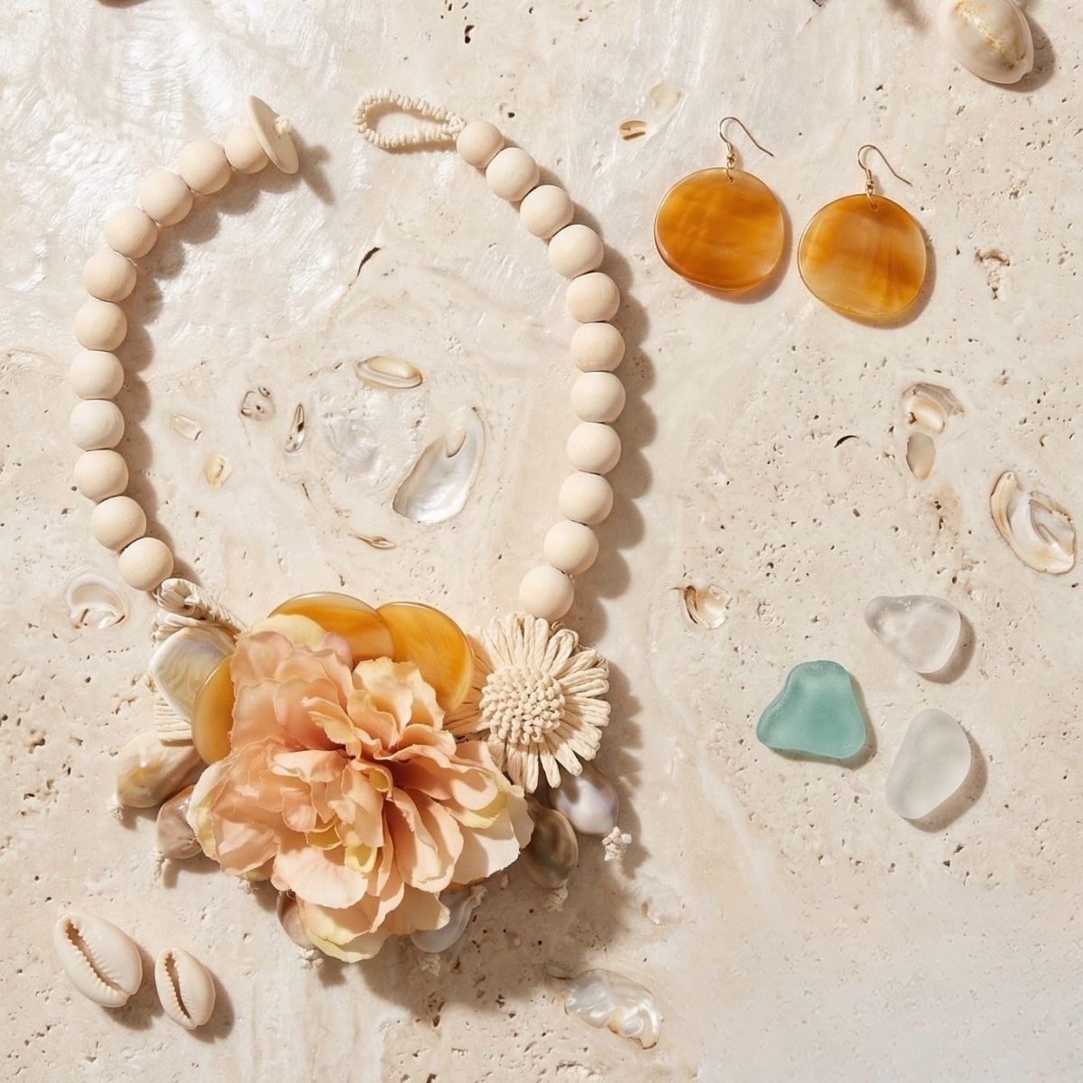 Cream floral garden statement necklace worn on neck close up