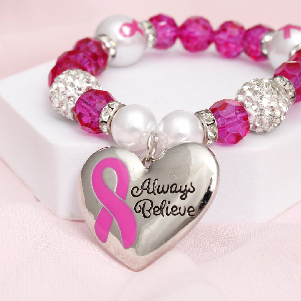 Pink glass bead breast cancer heart bracelet on wrist light catching