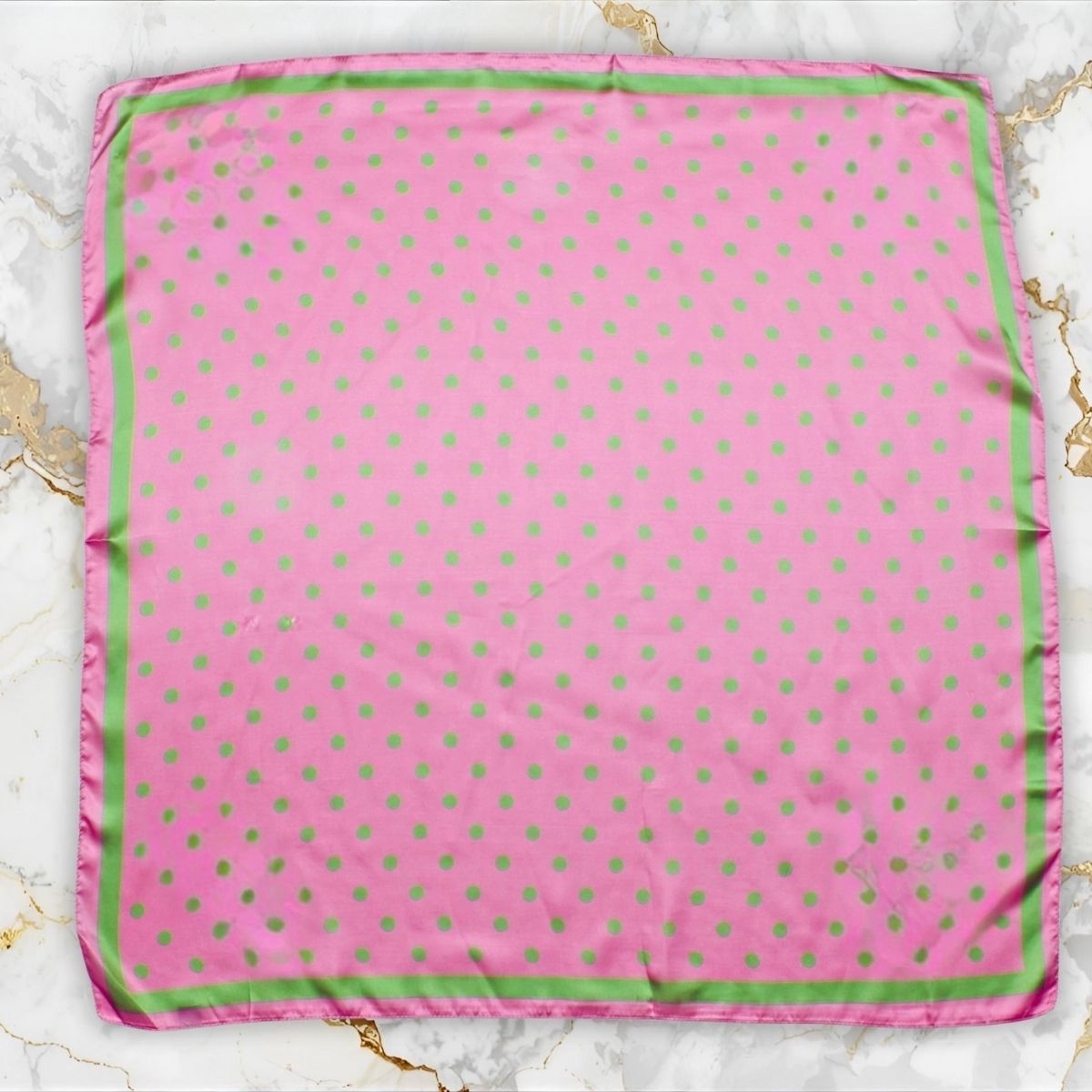 Pink green polka dot silky scarf folded showing pattern detail close up