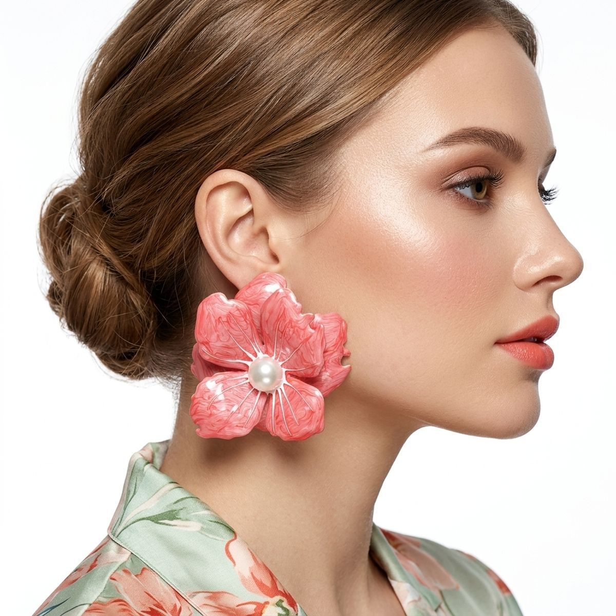 Pink oversized painted flower studs worn on ear bold tropical