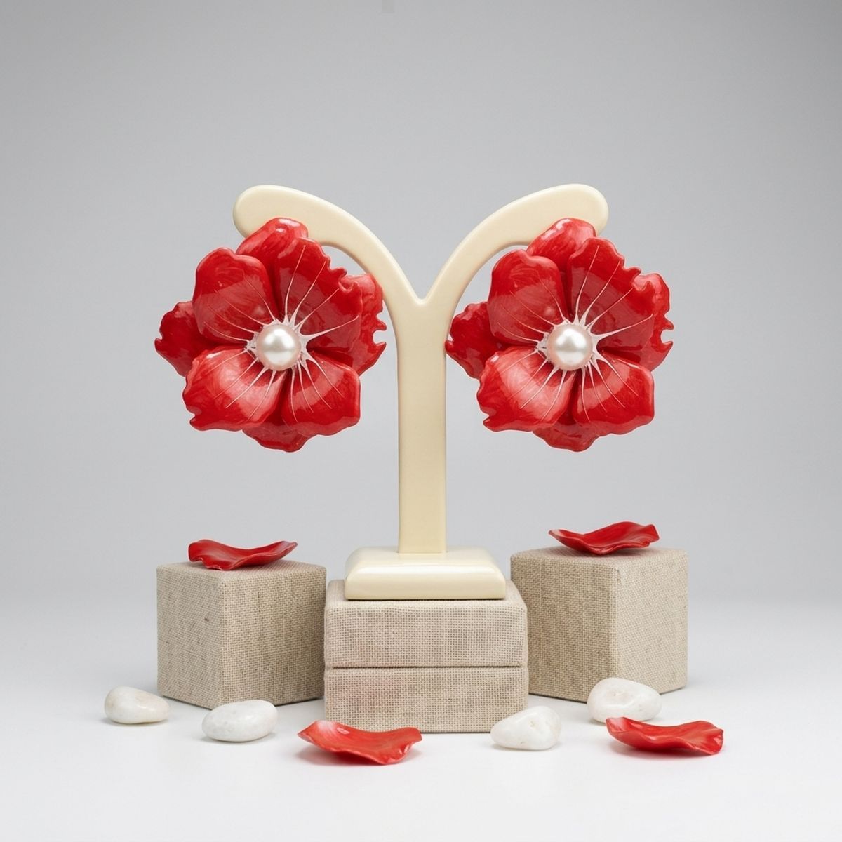 Red painted flower stud earrings worn on ear tropical bold