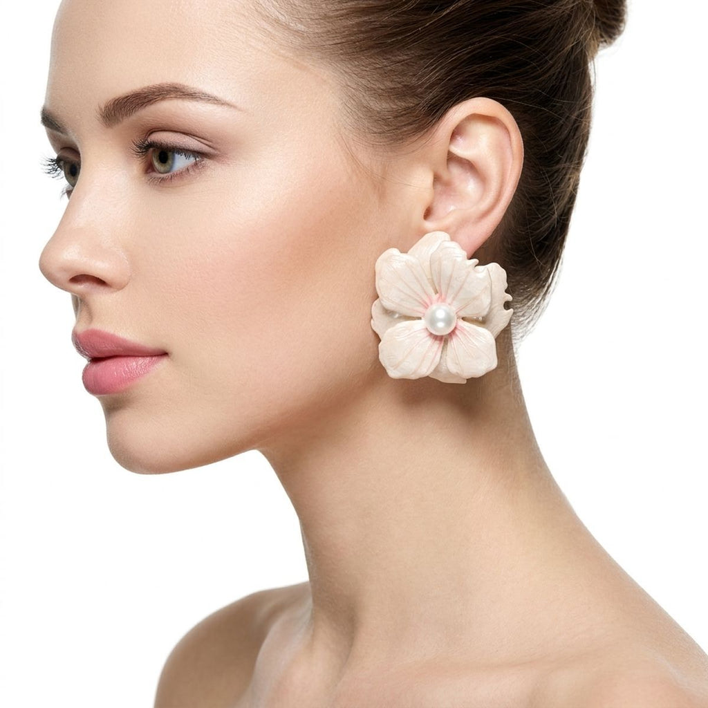 White painted flower stud earrings worn on ear tropical clean