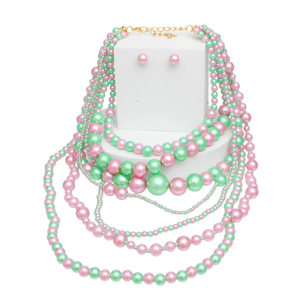 Pink green 7 strand pearl necklace flat lay showing all strands