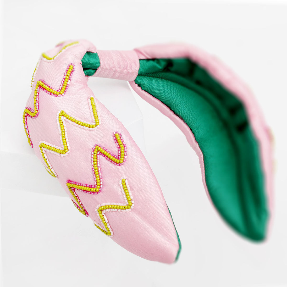 Pink green embroidered zig zag headband worn on head women front view